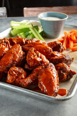 A view of a tray full of Buffalo wings.
