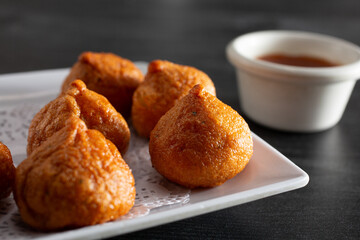 A closeup view of a plate of fried fish balls.
