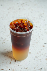 A view of a layered fruit tea drink.