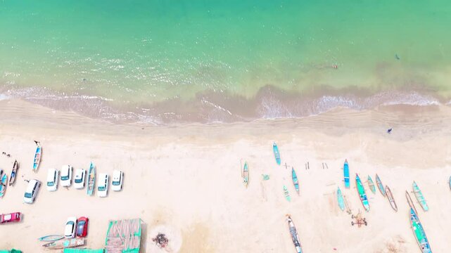 Aerial view of boat and car parked near sandy beach