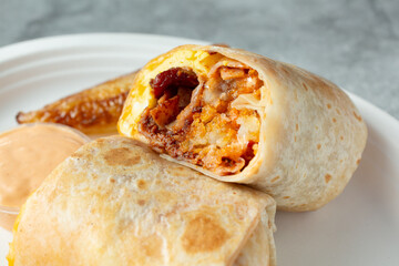 A closeup view of a breakfast burrito.