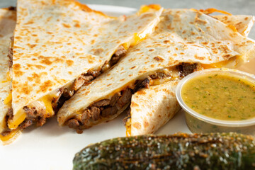 A closeup view of slices of a steak quesadilla.