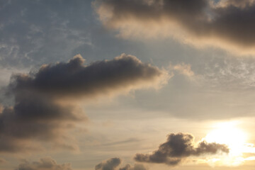 The sky is cloudy and the sun is shining through the clouds