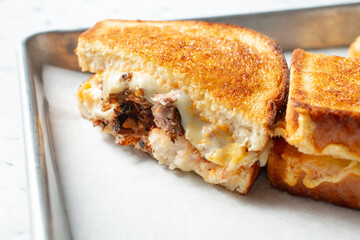 A closeup view of a steak and lobster melt.