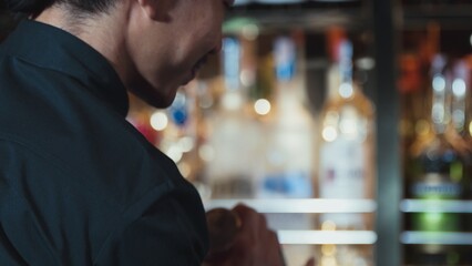 Closeup mixing hand bartender holding jigger to measure lemon juice into shaker design preparation for mixed cocktail bar. Special refresh drink showcasing nightlife mixology inviting club. Vinosity.