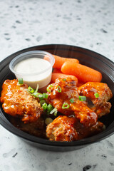 A view of a bowl of habanero chicken wings.