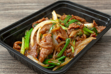 A closeup view of a container of Mongolian beef.