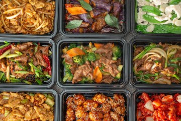 A top down view of several Chinese fast food entrees, as a background.