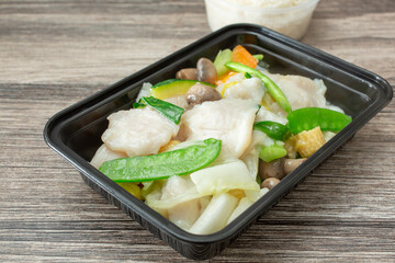 A closeup view of a fish stir fry entree.