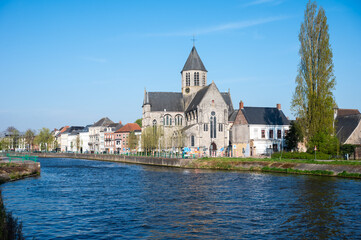 Fototapeta premium The Our Lady church at the River Scheldt, landscape view over Oudenaarde, East Flanders, Belgium
