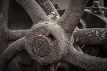 Wheel of a rusty agricultural machine.