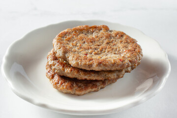 A closeup view of a stack of sausage patties.