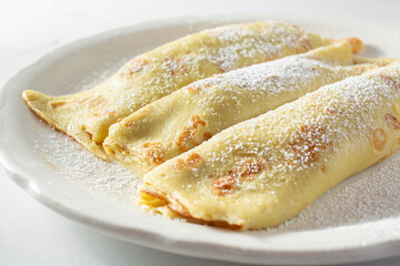 A closeup view of a plate of crepes.