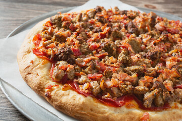 A closeup view of a meat lovers pizza.