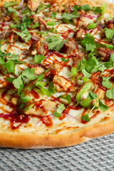 A closeup view of a BBQ chicken pizza.