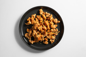 A top down view of a plate of popcorn chicken.