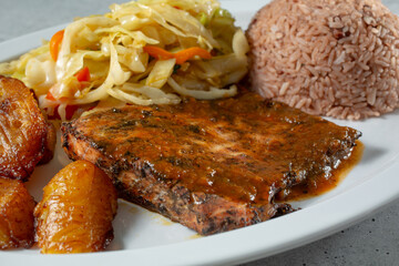A closeup view of a plate of jerk salmon.