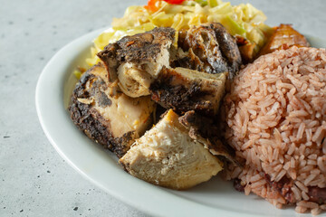 A closeup view of a plate of jerk chicken.