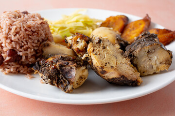 A closeup view of a plate of jerk chicken.