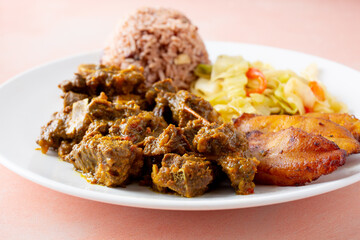 A view of a plate of curry goat.