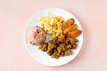 A top down view of a plate of curry goat.