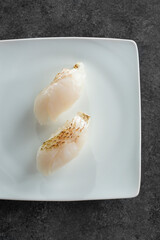 A top down view of a plate of blackthroat seaperch nigiri.