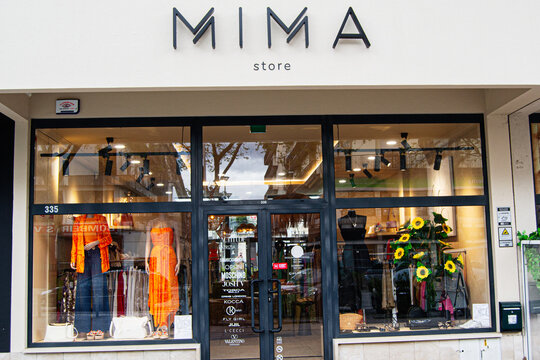 Fashion boutique Mima exterior with vibrant display in Fatima, Portugal captured in daylight