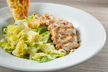 A closeup view of a chicken Caesar salad.