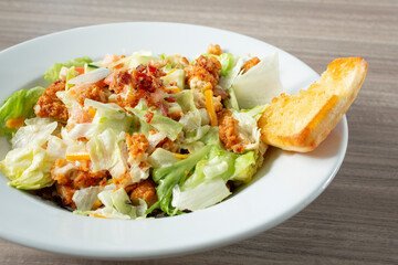 A closeup view of a popcorn chicken salad.
