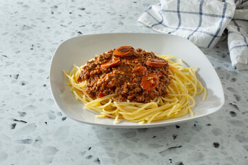 A closeup view of a plate of Filipino spaghetti.