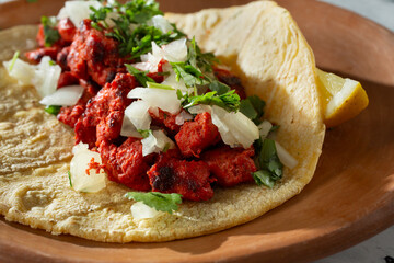 A closeup view of an al pastor street taco.