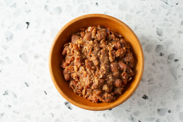 A top down view of a bowl of ful medames.