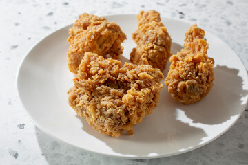 A view of a 4-piece extra crispy fried chicken combo, on a plate.