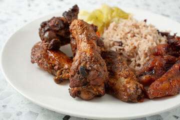 A closeup view of a plate of jerk chicken wings.