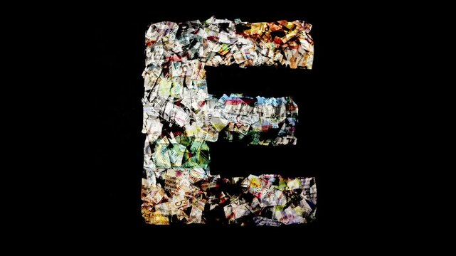 Alphabet with cut-up newspaper isolated on black 