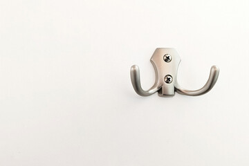One hook on a white wall. Conceptual background.