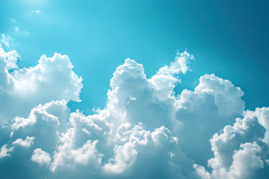 Blue sky with clouds reflecting on calm lake water, surrounded by lush green trees at the base of snow-capped mountains.