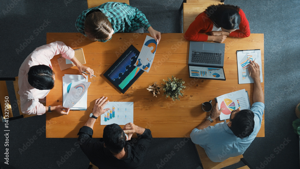 Poster top down view of manager holds tablet display increasing sales and placed on meeting table. group of