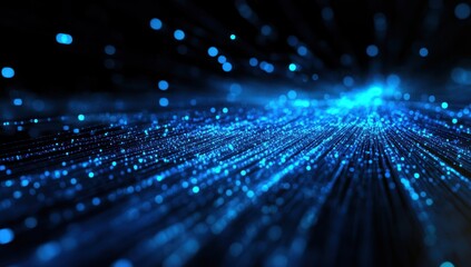 Abstract blue light trails and bokeh effects on a dark background.