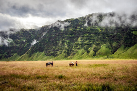 Two Horse Riders rural landscape, Bromo Tengger Semeru National Park, East Java, Indonesia