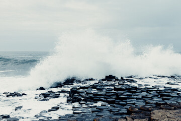 Storm Waves Crash Against the Giant’s Causeway Rocks with Dark Skies	