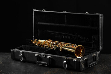 Jazz. Golden saxophone in case on black textured table © New Africa