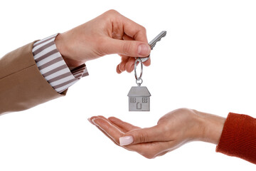 Real estate agent giving house key to new owner on white background, closeup