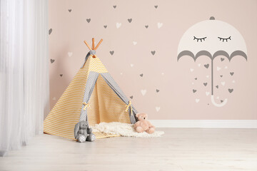 Cozy children's room with play tent and cute wallpaper. Stylish playroom interior