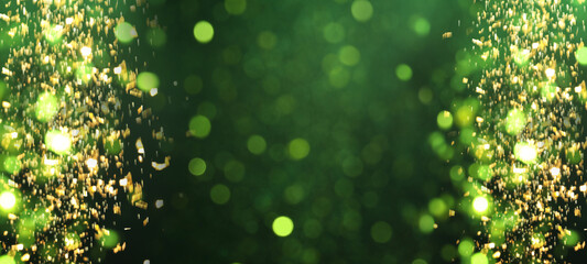 Sparkling glitter on dark green gradient background, bokeh. Abstract festive backdrop