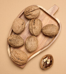 Walnut fruits on a brown background, close up