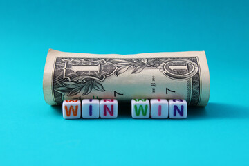One dollar bill next to the phrase WIN WIN