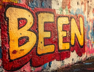 Obraz premium Urban Graffiti Art: Vibrant Yellow 'Been' on Red-hued Wall