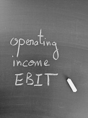 Operating Income and EBIT: Financial metrics on a chalkboard with chalk representing business...