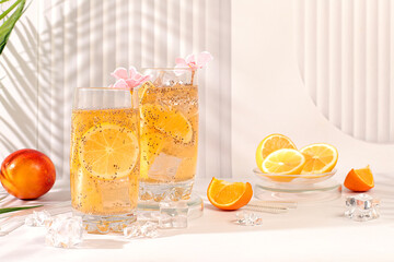 Modern still life with citrus fruits. Diet vegan cocktail with chia seeds, orange, lime, violet and ice. Detox diet and weight loss concept. Summer banner and screen template.